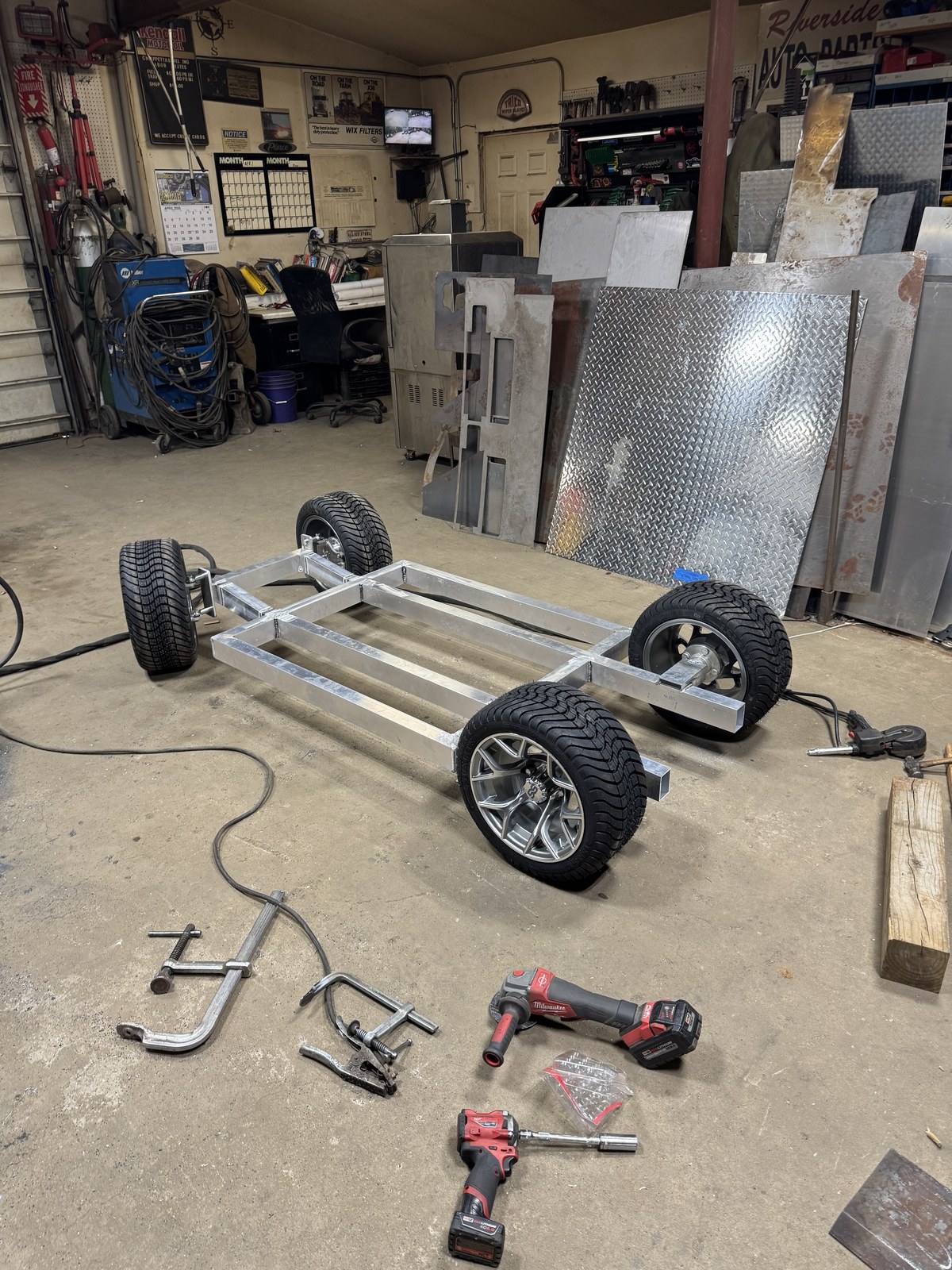 Atlas Pit Box rolling chassis on the shop floor, aluminum frame mounted on golf cart wheels