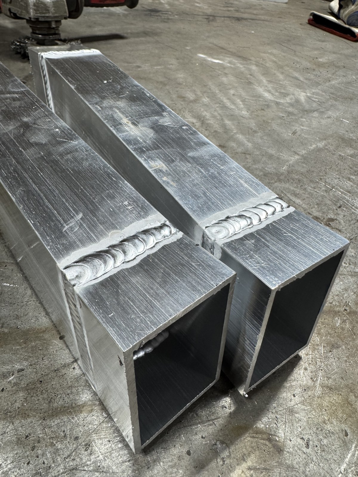 Close-up of clean stack-of-dimes TIG weld bead on 6061 aluminum square box tube frame
