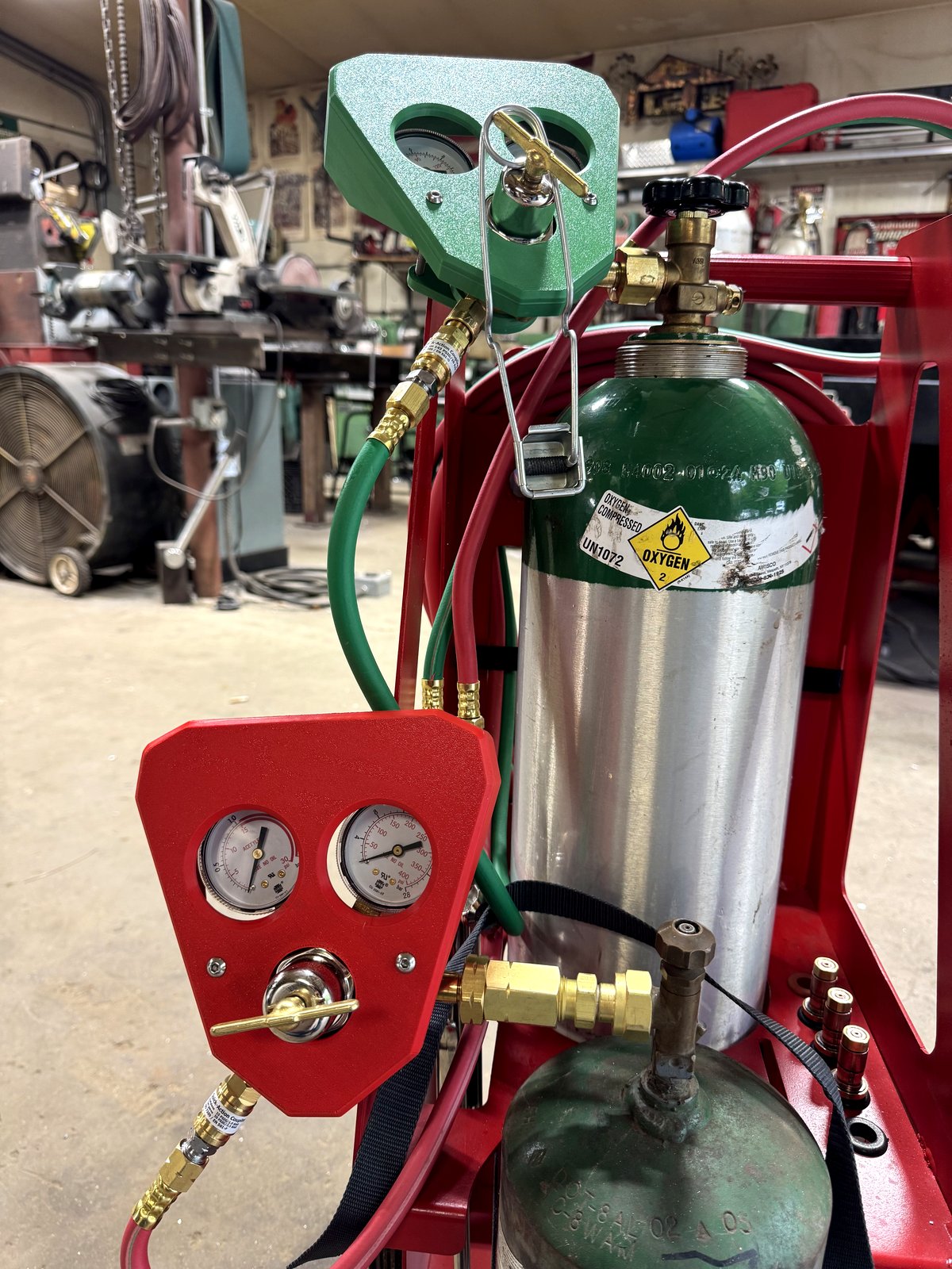 RegShield SM30 protective gauge guards installed in matched green and red on an oxygen and acetylene welding cart