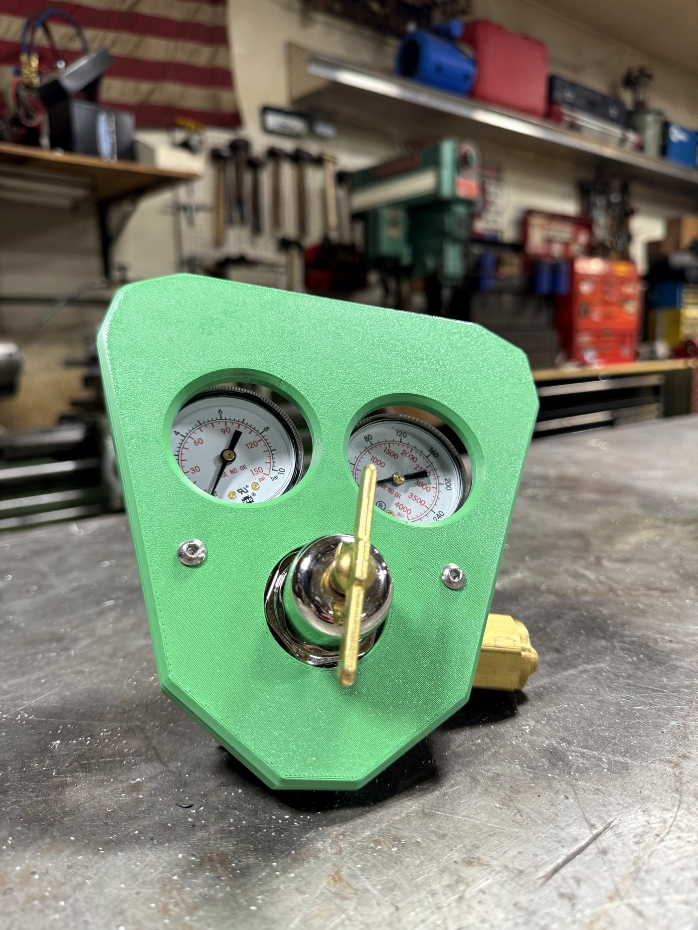 RegShield SM30 at three-quarter angle, bench-mounted, with American flag and shop tools in background