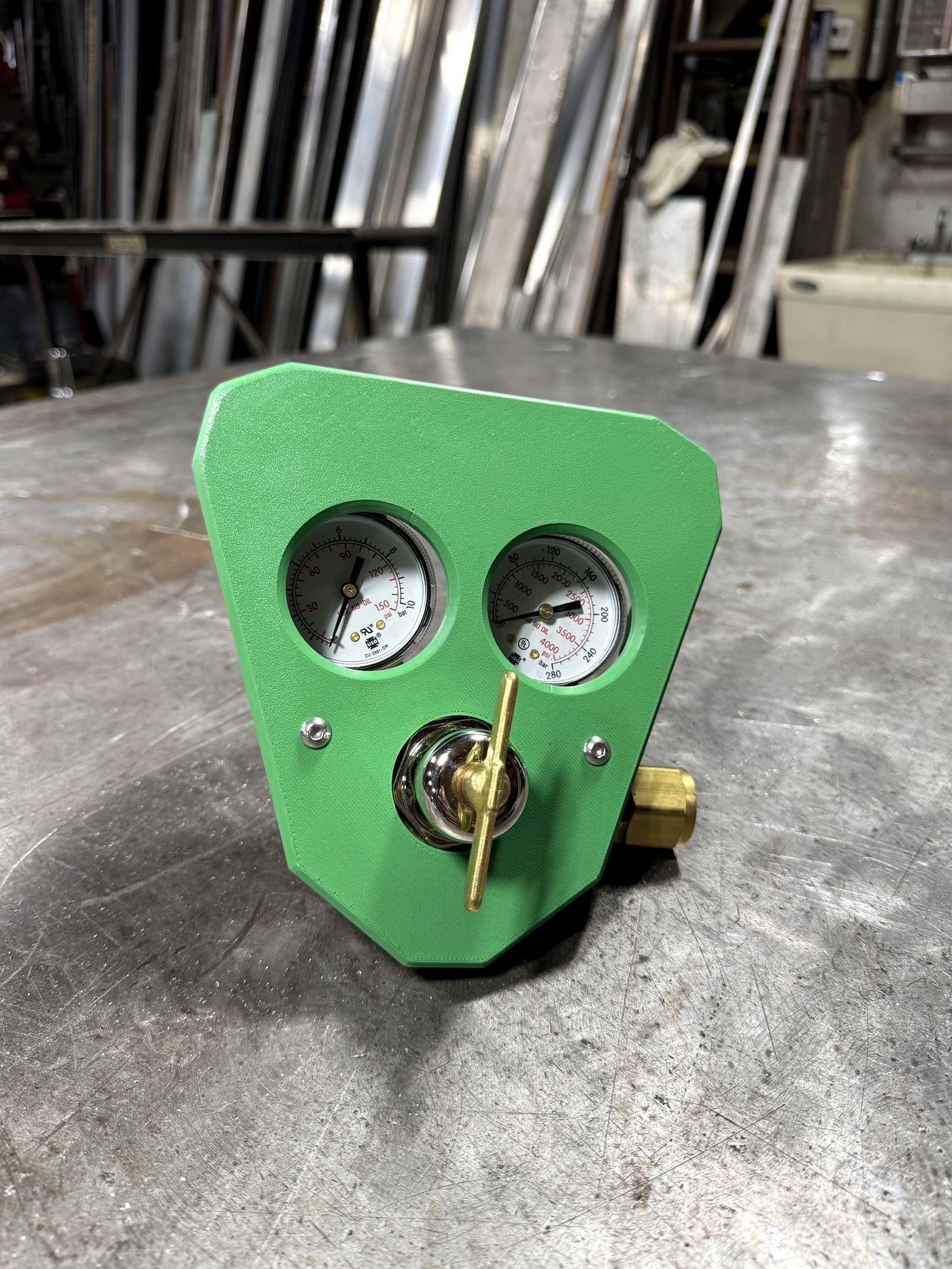 RegShield SM30 oxygen guard, head-on bench shot showing both gauge cutouts and the brass T-handle